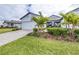 Charming home with a well-manicured lawn, brick driveway, and a beautiful palm tree in the front yard at 8435 Ocean Tides Cv, Parrish, FL 34219