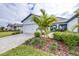 Charming home with a well-manicured lawn, brick driveway, and a beautiful palm tree in the front yard at 8435 Ocean Tides Cv, Parrish, FL 34219