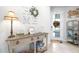 Home foyer with console table, decor and interior glass door to office at 8435 Ocean Tides Cv, Parrish, FL 34219