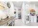 Bright foyer featuring a decorative table and decor and glass door leading to an office at 8435 Ocean Tides Cv, Parrish, FL 34219