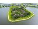 Island in a pond with walking path and mature trees near residential homes at 8435 Ocean Tides Cv, Parrish, FL 34219