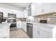 Updated kitchen with stainless steel appliances, quartz countertops, and contemporary backsplash at 8435 Ocean Tides Cv, Parrish, FL 34219