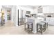 A well-lit kitchen with stainless appliances and an island with seating, enhanced by stylish decor at 8435 Ocean Tides Cv, Parrish, FL 34219