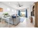 Living room featuring large windows, sliding doors, and a view of the landscaped yard at 8435 Ocean Tides Cv, Parrish, FL 34219