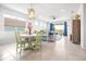 Open-concept living space with a dining area, plush seating, and sliding doors to the outside at 8435 Ocean Tides Cv, Parrish, FL 34219