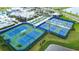 Aerial view of tennis and pickleball courts with green and blue surfaces at 8435 Ocean Tides Cv, Parrish, FL 34219