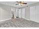 This carpeted bedroom has a ceiling fan, closet and entrance to a bathroom at 8640 Tahoe Ct # 16, Tampa, FL 33614
