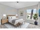 Well-lit bedroom with a comfortable bed, stylish furnishings, and a window offering natural light and outdoor views at 8640 Tahoe Ct # 16, Tampa, FL 33614
