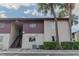 Exterior of a multi-unit building featuring stairs leading to the second floor, with mature trees adding character at 8640 Tahoe Ct # 16, Tampa, FL 33614