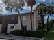 Inviting exterior view of a two-story condo nestled among palm trees and mature landscaping at 8640 Tahoe Ct # 16, Tampa, FL 33614