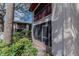 Exterior view of building featuring a screened lanai and balcony with lush landscaping at 8640 Tahoe Ct # 16, Tampa, FL 33614
