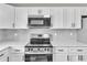 Bright modern kitchen with stainless steel appliances, white subway tile backsplash, and ample countertop space at 8640 Tahoe Ct # 16, Tampa, FL 33614