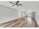 Open concept living room with hardwood floors, a ceiling fan, and an adjacent kitchen at 8640 Tahoe Ct # 16, Tampa, FL 33614