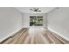 Inviting living area with laminate flooring, a ceiling fan, and sliding glass doors to a private, landscaped outdoor space at 8640 Tahoe Ct # 16, Tampa, FL 33614