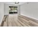 Bright, open living area featuring wood-look floors and sliding glass doors to the outside at 8640 Tahoe Ct # 16, Tampa, FL 33614
