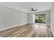 This living room is painted a neutral grey and has wood floors and patio access at 8640 Tahoe Ct # 16, Tampa, FL 33614