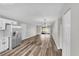 A well-lit open-concept living room and kitchen with stainless steel refrigerator and outdoor access at 8640 Tahoe Ct # 16, Tampa, FL 33614