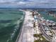 Expansive aerial view capturing the serene coastline, beachside properties, and the scenic roadway, highlighting a coastal lifestyle at 9715 Harrell Ave # 22, Treasure Island, FL 33706