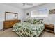 Comfortable bedroom with tropical patterned bedding, dresser, and lots of natural light at 9715 Harrell Ave # 22, Treasure Island, FL 33706