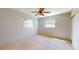 Bedroom with neutral walls, carpet flooring, two windows and ceiling fan at 1015 55Th S Ave, St Petersburg, FL 33705