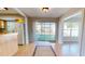 Bright dining area featuring sliding glass doors leading to the backyard and an open view to the kitchen with light wood cabinets at 1015 55Th S Ave, St Petersburg, FL 33705