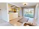 Open-concept dining area with sliding glass doors to the backyard and an adjacent kitchen with wood cabinetry at 1015 55Th S Ave, St Petersburg, FL 33705