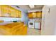 Eat-in kitchen boasts classic cabinetry, white appliances, and tile flooring, providing a functional and welcoming space at 1015 55Th S Ave, St Petersburg, FL 33705