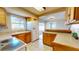 Kitchen featuring tile countertops, white appliances, and ample natural light, creating a functional and inviting space at 1015 55Th S Ave, St Petersburg, FL 33705