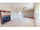 Living room with a carpeted floor, large windows, and a fireplace with decorative tiles at 1015 55Th S Ave, St Petersburg, FL 33705