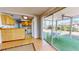 View of the eat-in kitchen and an outdoor dining area with sliding glass doors, promoting seamless indoor-outdoor living at 1015 55Th S Ave, St Petersburg, FL 33705