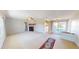 Spacious living room featuring a fireplace, neutral carpet, and sliding glass doors, offering a view of the backyard at 1015 55Th S Ave, St Petersburg, FL 33705