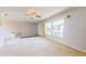 Bright, carpeted living room with multiple windows and a welcoming front door at 1015 55Th S Ave, St Petersburg, FL 33705