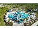 Aerial view of a resort-style pool area with a water slide and many lounge chairs at 10410 Cross River Trl, Parrish, FL 34219