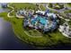Stunning aerial view of community pool and recreation area with lush landscaping and inviting amenities at 10410 Cross River Trl, Parrish, FL 34219