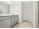 Bathroom with a double sink vanity, tiled floor, and a framed mirror at 10410 Cross River Trl, Parrish, FL 34219