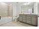Modern bathroom with bathtub and large mirror at 10410 Cross River Trl, Parrish, FL 34219