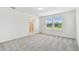 Bedroom with plush neutral carpet and natural light flowing in from the two windows with blinds at 10410 Cross River Trl, Parrish, FL 34219