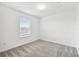 View of a spare bedroom with neutral carpet and single window at 10410 Cross River Trl, Parrish, FL 34219