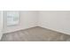 Minimalist bedroom featuring a carpeted floor, white walls, and a single window at 10410 Cross River Trl, Parrish, FL 34219