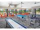 Fun game room featuring a shuffleboard table, billiards, foosball and tables for residents at 10410 Cross River Trl, Parrish, FL 34219