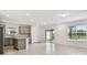 Open-concept kitchen and dining area featuring stainless steel appliances and backyard access at 10410 Cross River Trl, Parrish, FL 34219