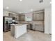 Bright kitchen boasts stainless steel appliances, gray cabinetry, and a functional center island at 10410 Cross River Trl, Parrish, FL 34219