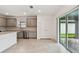 Open kitchen area with stainless steel appliances, gray cabinets, and sliding door access to the patio at 10410 Cross River Trl, Parrish, FL 34219