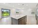 Spacious kitchen area offering a center island, views of the backyard, and sliding glass door access at 10410 Cross River Trl, Parrish, FL 34219