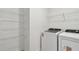 Laundry room featuring a washing machine, dryer, and wire shelving at 10410 Cross River Trl, Parrish, FL 34219
