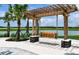 Inviting outdoor seating area with a swing under a pergola, ideal for relaxation and enjoying the peaceful surroundings at 10410 Cross River Trl, Parrish, FL 34219