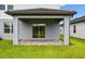 Outdoor patio with a stone brick floor and grass in the backyard at 10410 Cross River Trl, Parrish, FL 34219