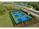 Aerial view of well-maintained pickleball courts, perfect for active residents and social gatherings at 10410 Cross River Trl, Parrish, FL 34219