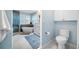 Bathroom with a freestanding tub, glass shower, double vanity, white cabinets, and a separate toilet at 10627 Hatteras Dr, Tampa, FL 33615