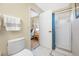 Bathroom with a toilet and shower, and view into an adjacent bedroom at 10627 Hatteras Dr, Tampa, FL 33615